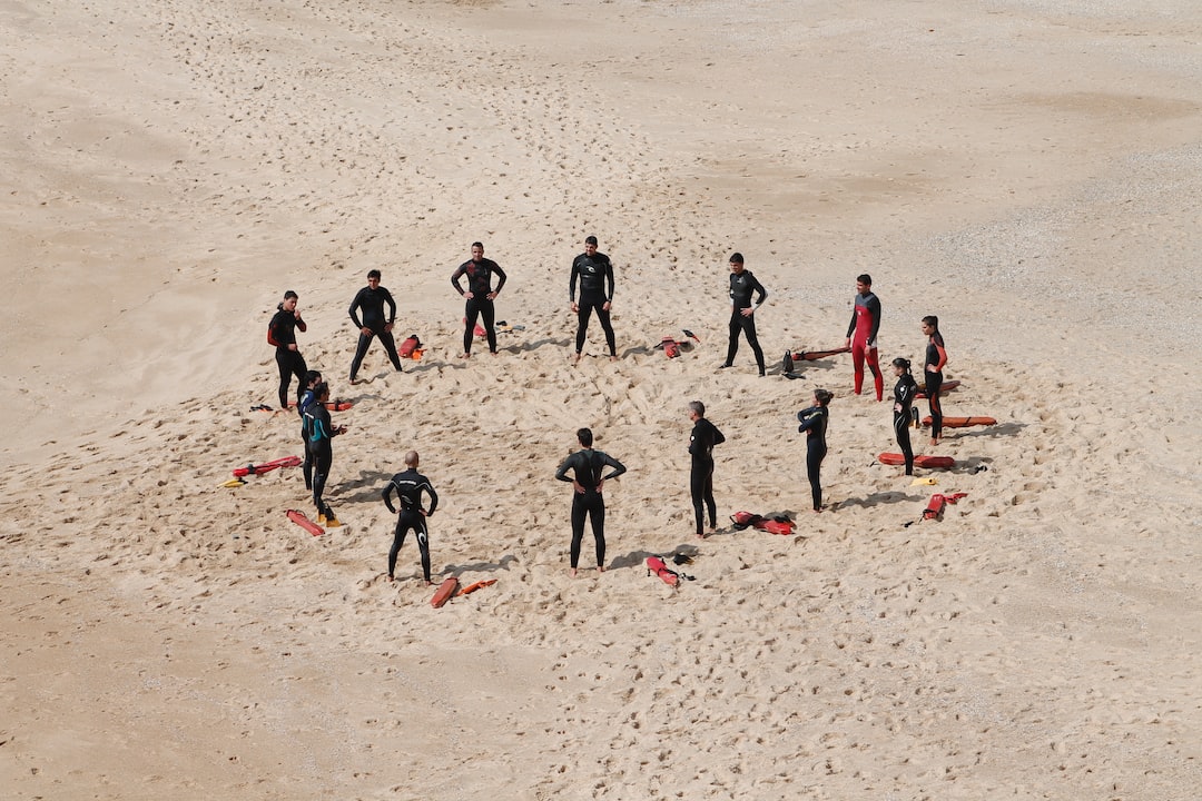 people standing forming a circle during daytime