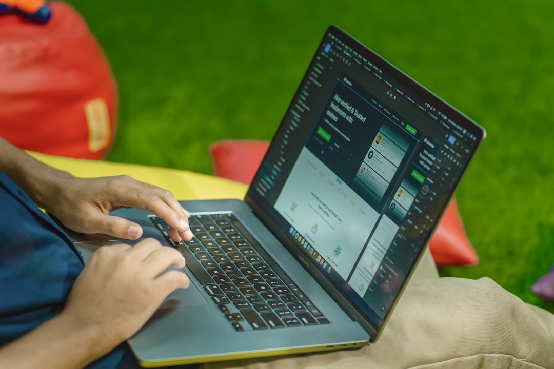 ❓ Personal Trainer Certification FAQs by Virtual Personal Trainers a person sitting on the grass using a laptop